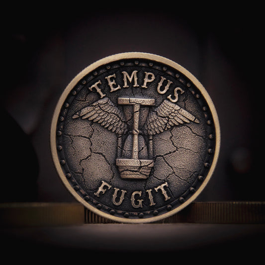 Antique-style brass EDC coin featuring the Latin phrase “Tempus Fugit” with a winged hourglass at the centre, symbolizing the passage of time.