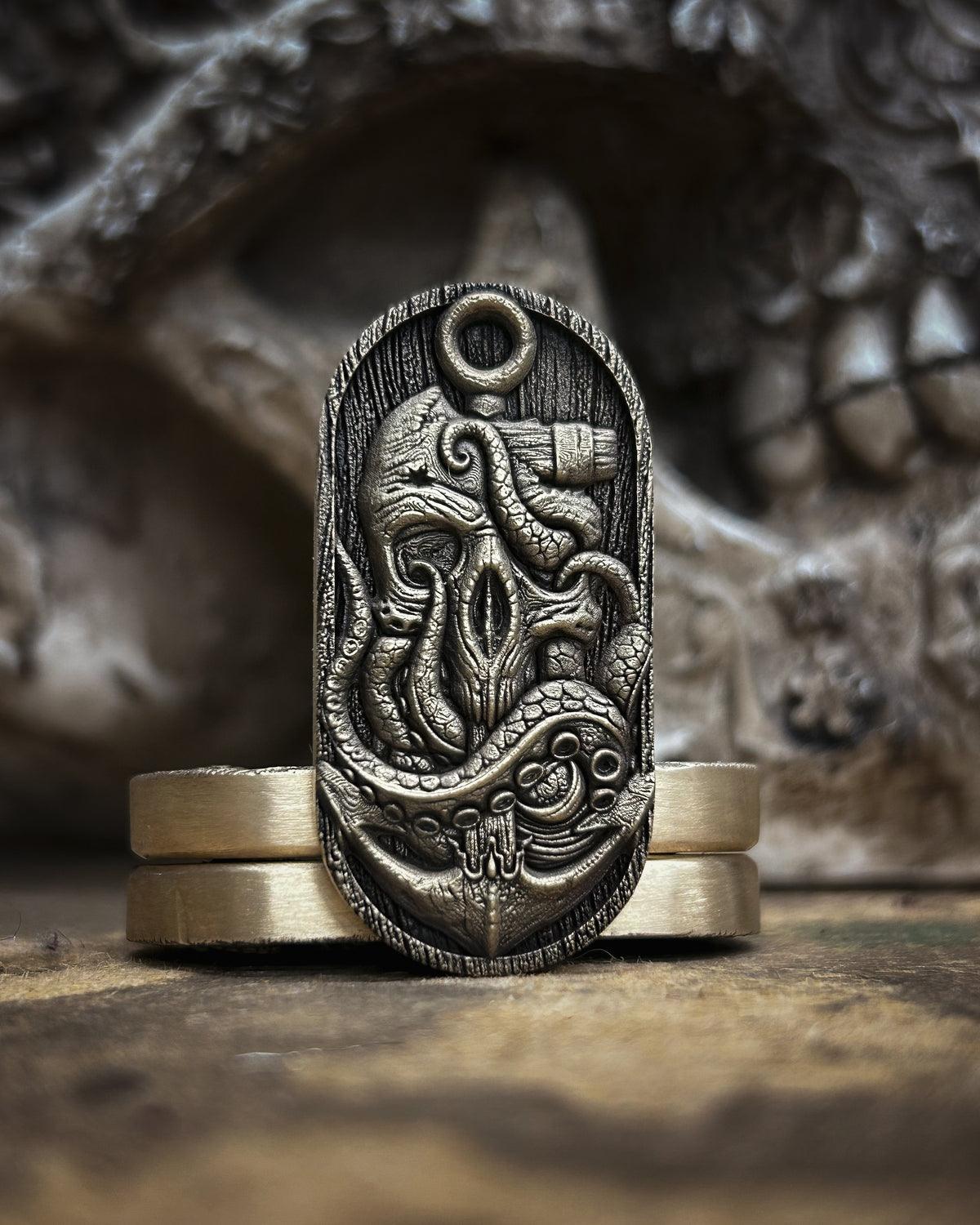 Front view of the pirate skull fidget pill with an eye patch, tricorn hat, ship, treasure map and rope-wrapped anchor.