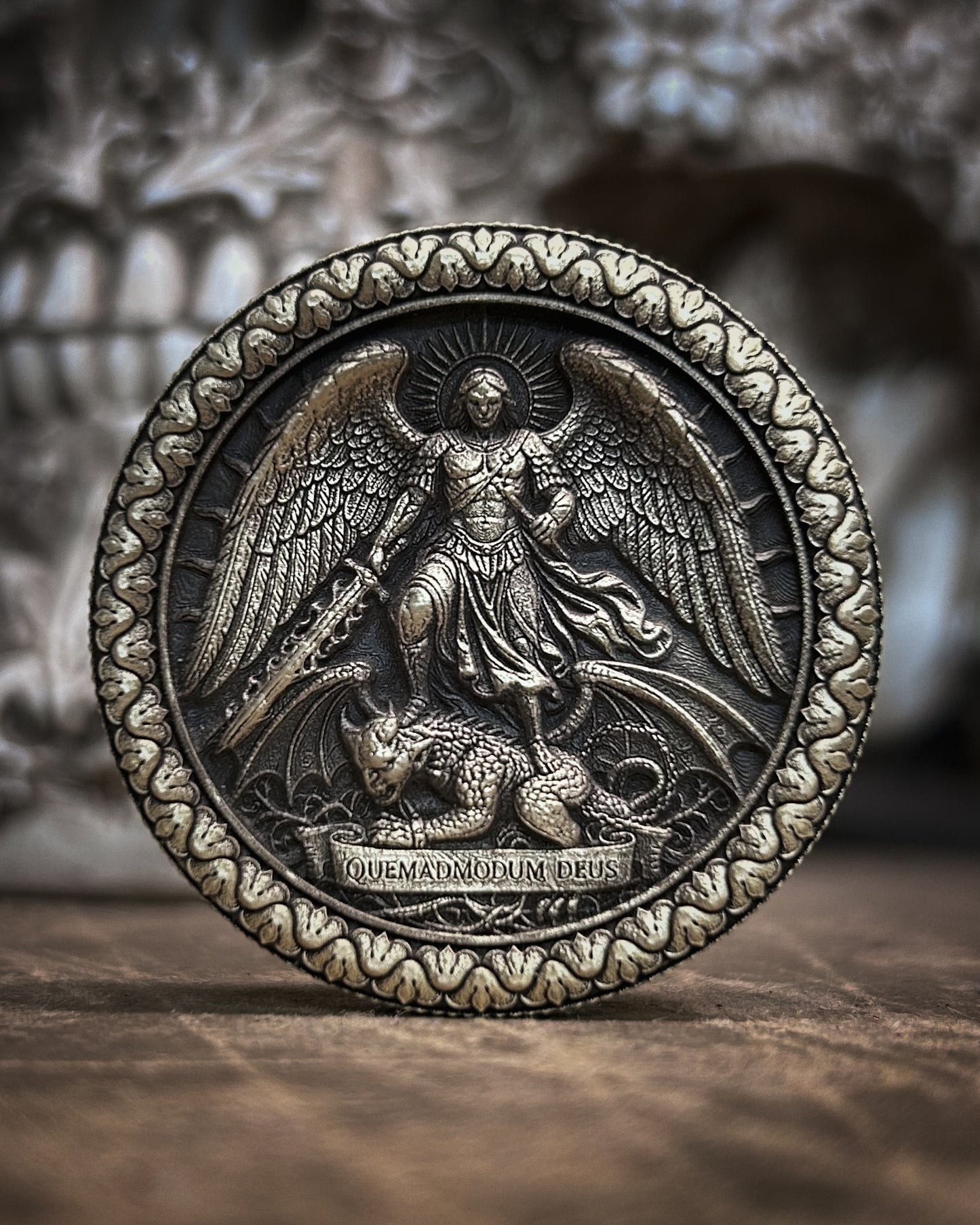 Decorative coin with angelic design on a wooden surface