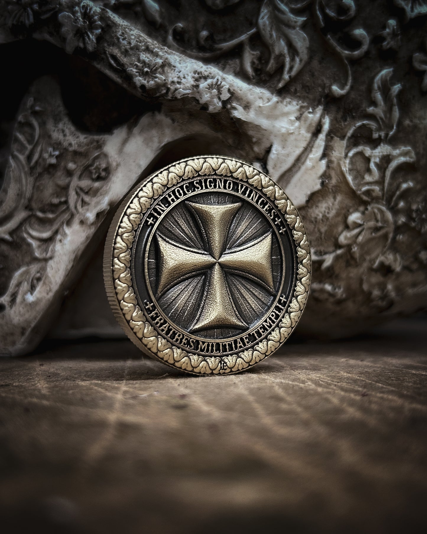 Decorative coin with intricate design on a textured surface