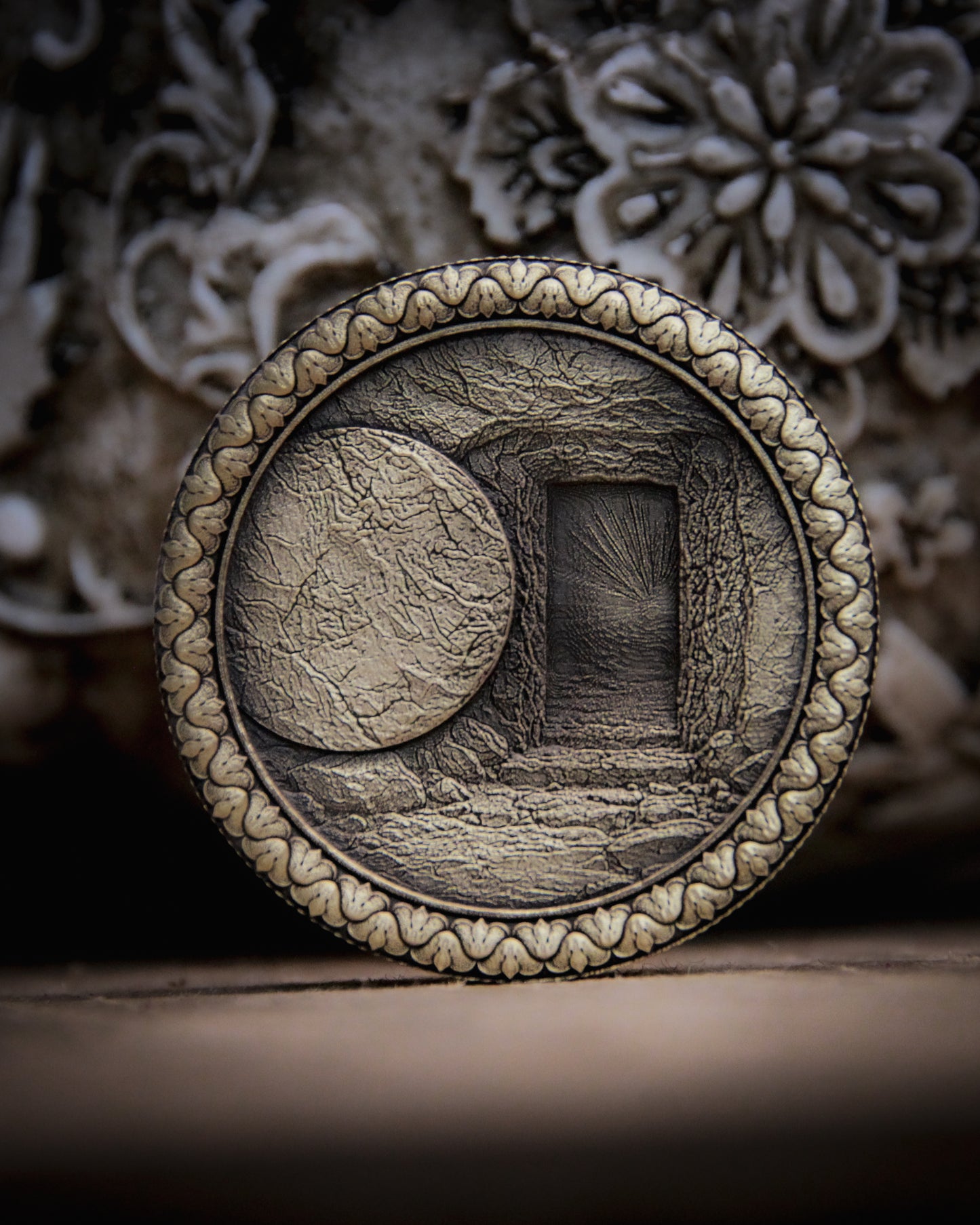 Decorative coin with the empty tomb intricate design on a textured surface