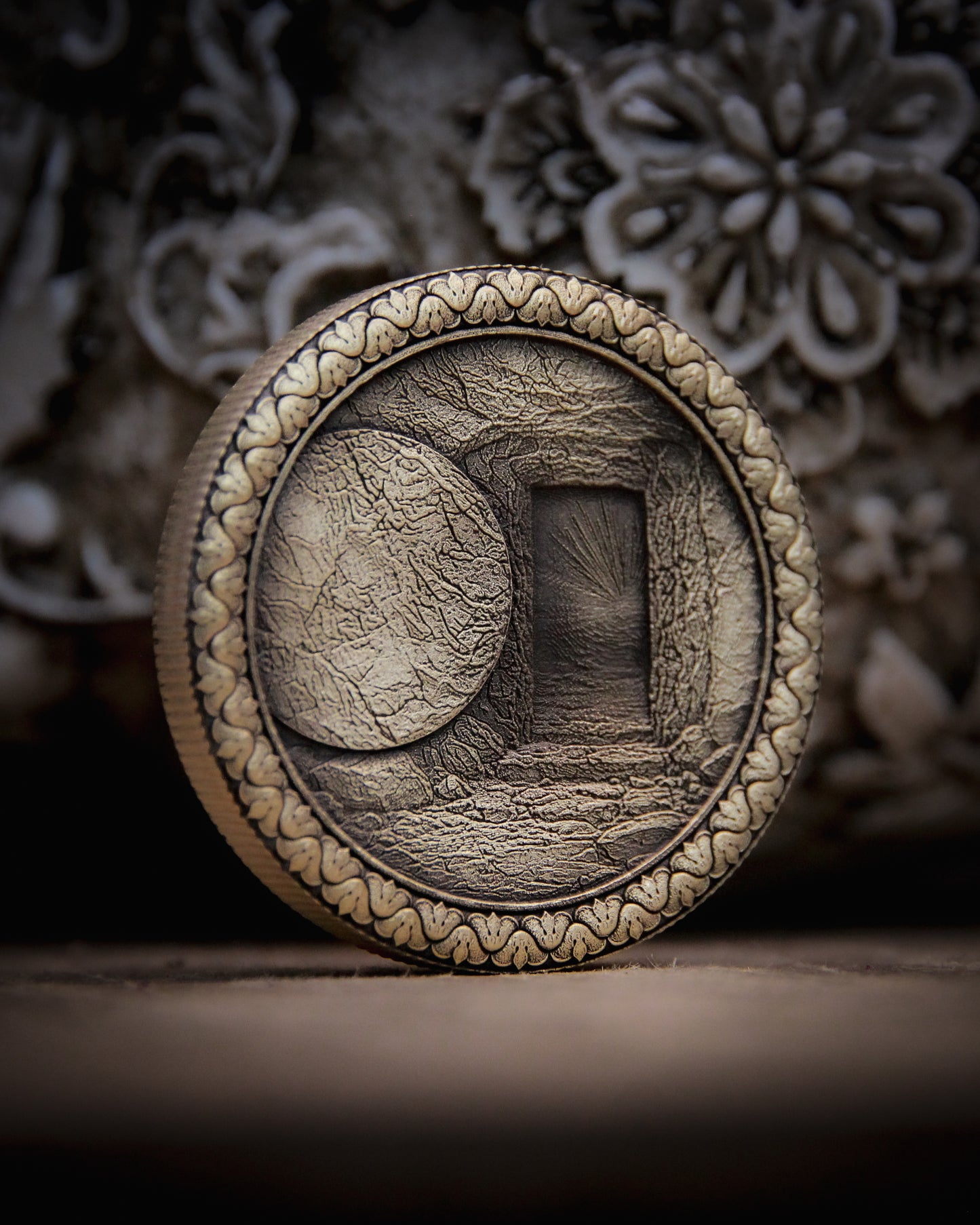 Decorative coin with embossed design on a textured surface